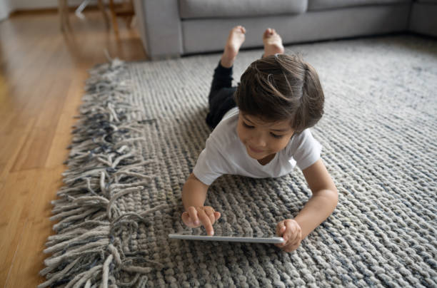 Cute girl laying on carpet floor | Vic's Carpet & Flooring